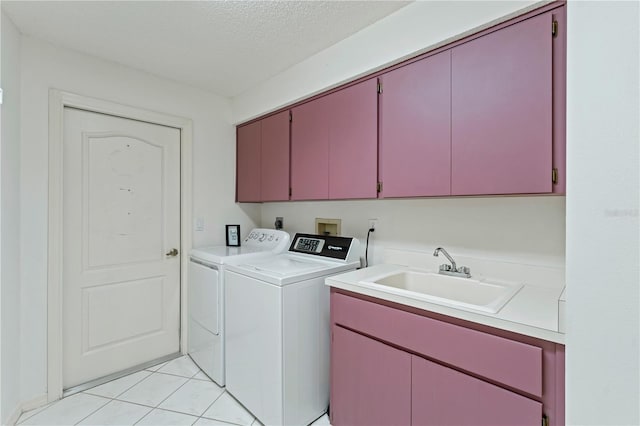 18561 Winding Oaks Blvd, Hudson, FL 34667 - laundry area featuring cabinet space, washer and clothes dryer, light tile patterned flooring, and a textured ceiling