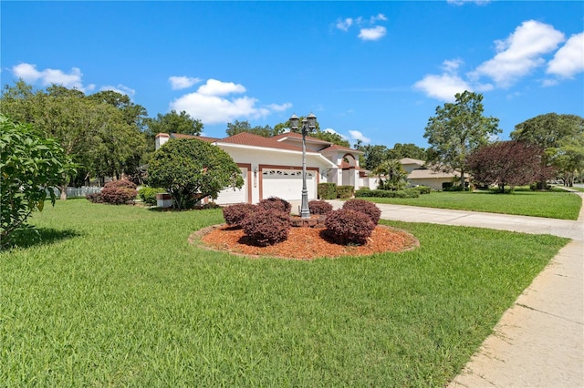 18561 Winding Oaks Blvd, Hudson, FL 34667 - view of front of property with a garage, a front yard, concrete driveway, and stucco siding