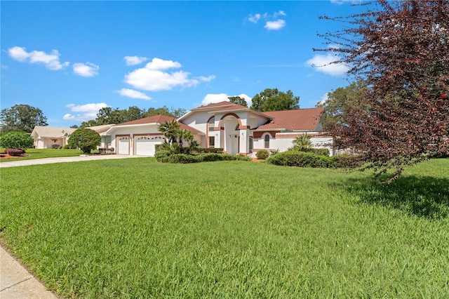 18561 Winding Oaks Blvd, Hudson, FL 34667 - mediterranean / spanish house with a garage, driveway, a front yard, stucco siding, and a tile roof