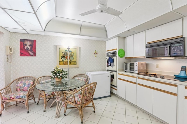 5200 Brittany Dr S Unit 1501, Saint Petersburg, FL 33715 - kitchen featuring black appliances, wallpapered walls, light countertops, ceiling fan, and white cabinets