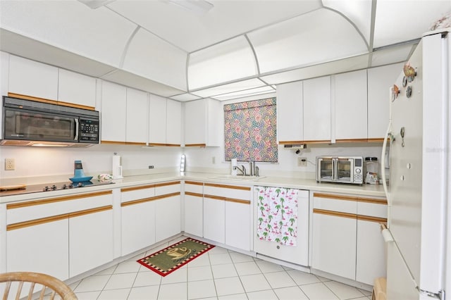 5200 Brittany Dr S Unit 1501, Saint Petersburg, FL 33715 - kitchen with black appliances, light countertops, and white cabinets