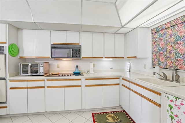 5200 Brittany Dr S Unit 1501, Saint Petersburg, FL 33715 - kitchen with black appliances, light countertops, and white cabinetry