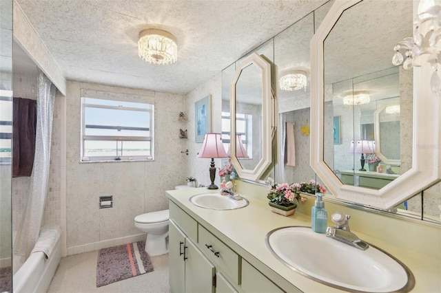 5200 Brittany Dr S Unit 1501, Saint Petersburg, FL 33715 - full bath featuring double vanity, a textured ceiling, shower / bathtub combination with curtain, and a chandelier