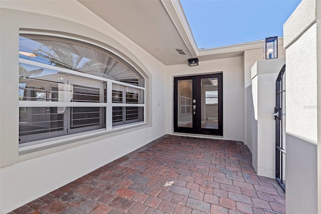 11225 4th St E, Treasure Island, FL 33706 - entrance to property featuring french doors and stucco siding