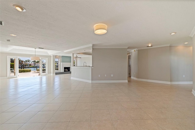 11225 4th St E, Treasure Island, FL 33706 - unfurnished living room featuring ornamental molding, a textured ceiling, light tile patterned floors, recessed lighting, and a fireplace