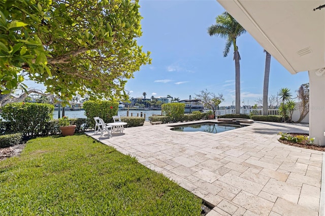 11225 4th St E, Treasure Island, FL 33706 - view of pool featuring a patio area, a yard, and a water view