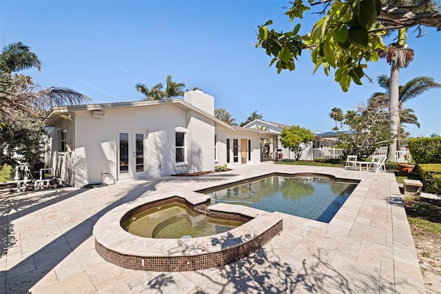 11225 4th St E, Treasure Island, FL 33706 - view of pool with french doors, a patio area, and an in-ground hot tub