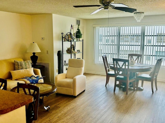 5623 80th St N Unit 406, Saint Petersburg, FL 33709 - dining space featuring a ceiling fan, wood finished floors, plenty of natural light, and a textured ceiling
