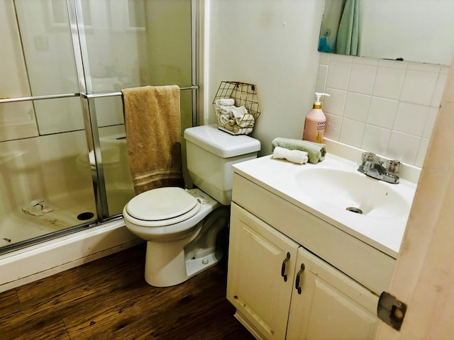5623 80th St N Unit 406, Saint Petersburg, FL 33709 - bathroom with a shower stall, vanity, wood finished floors, and decorative backsplash