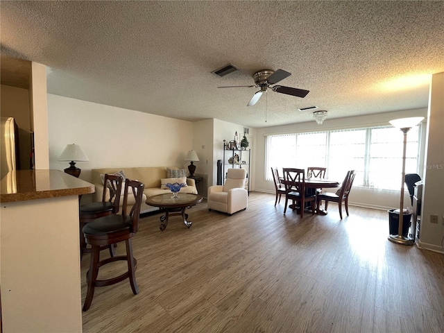5623 80th St N Unit 406, Saint Petersburg, FL 33709 - living area featuring a ceiling fan, wood finished floors, and a textured ceiling