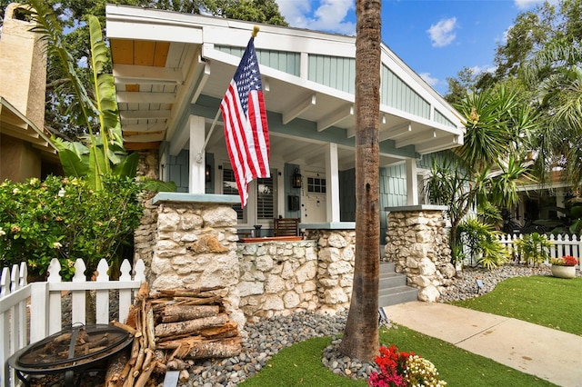 711 S Bungalow Ter, Tampa, FL 33606 - view of front facade featuring stone siding and covered porch