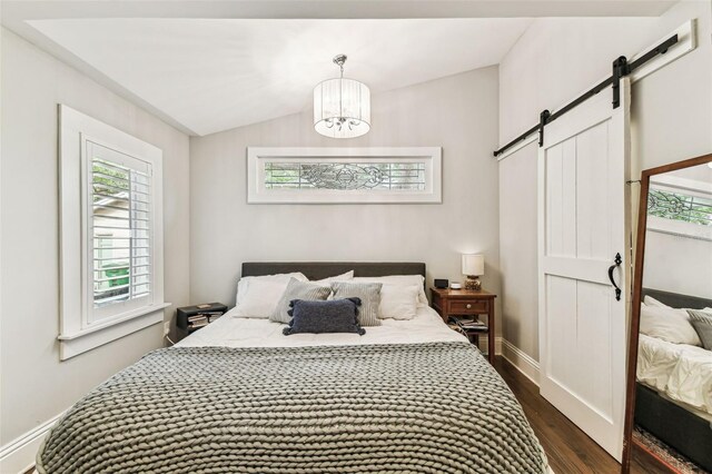 711 S Bungalow Ter, Tampa, FL 33606 - bedroom featuring a barn door, dark wood-style floors, multiple windows, a chandelier, and vaulted ceiling