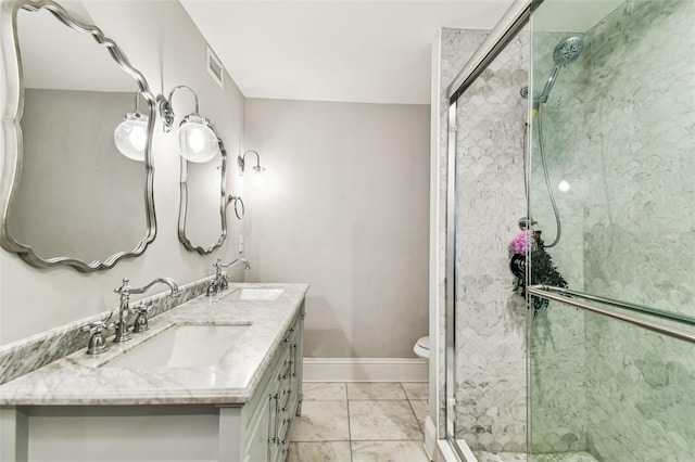 711 S Bungalow Ter, Tampa, FL 33606 - bathroom featuring a shower stall, double vanity, and marble finish flooring