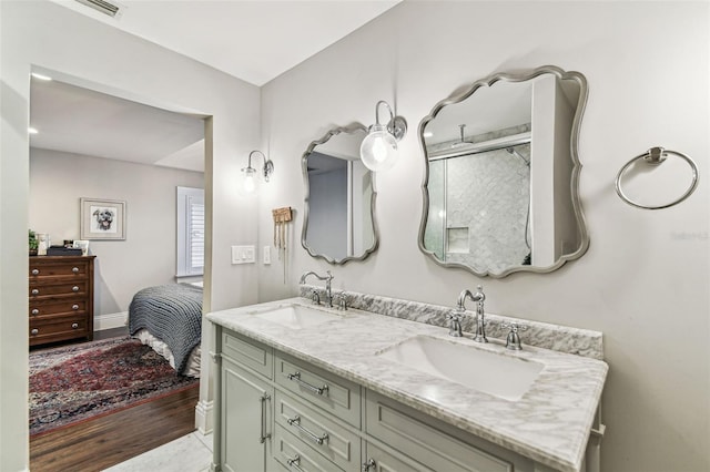 711 S Bungalow Ter, Tampa, FL 33606 - full bath with double vanity, wood finished floors, and connected bathroom