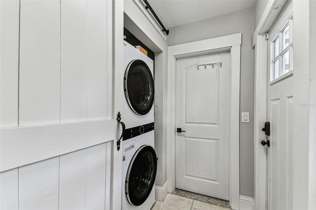 711 S Bungalow Ter, Tampa, FL 33606 - laundry area with stacked washer / drying machine and light tile patterned floors
