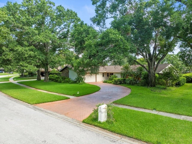 4209 Winding Willow Dr, Tampa, FL 33618 - view of front of home with decorative driveway, a front lawn, and a garage