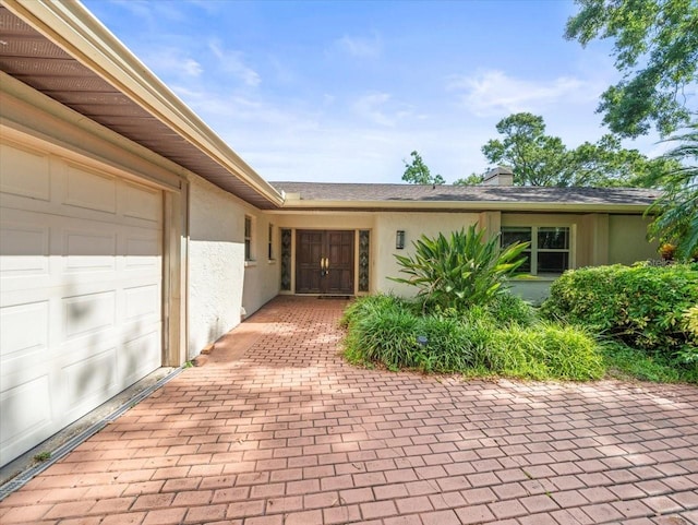 4209 Winding Willow Dr, Tampa, FL 33618 - view of front facade with stucco siding and a chimney