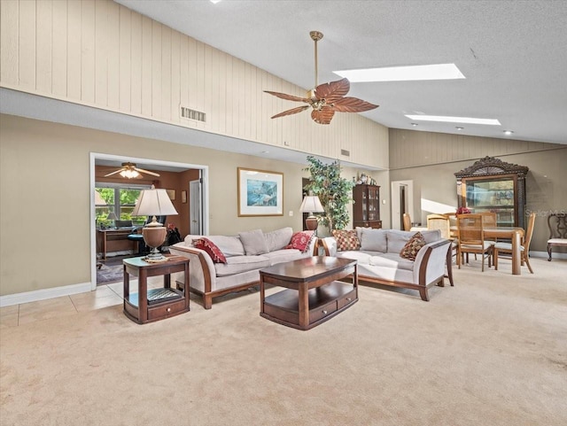 4209 Winding Willow Dr, Tampa, FL 33618 - carpeted living area featuring a ceiling fan, high vaulted ceiling, a skylight, and a textured ceiling