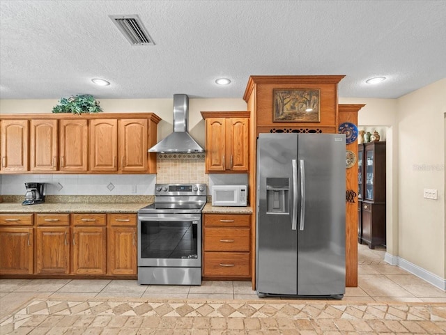4209 Winding Willow Dr, Tampa, FL 33618 - kitchen featuring appliances with stainless steel finishes, wall chimney range hood, light tile patterned floors, brown cabinets, and a textured ceiling