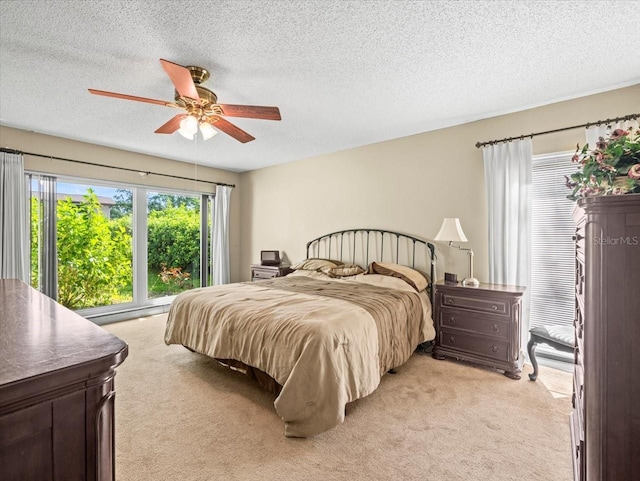 4209 Winding Willow Dr, Tampa, FL 33618 - bedroom featuring light carpet, a textured ceiling, and a ceiling fan