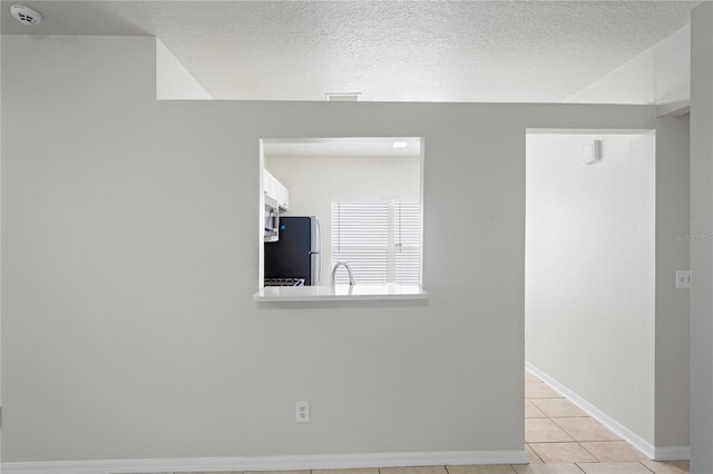 456 Summer Sails Dr, Valrico, FL 33594 - empty room featuring a smoke detector, light tile patterned floors, and a textured ceiling