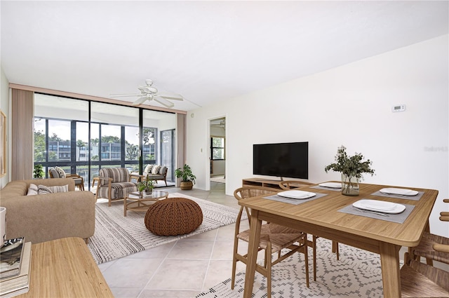 14130 Rosemary Ln Unit 4215, Largo, FL 33774 - living room featuring light tile patterned floors, a ceiling fan, and a wall of windows