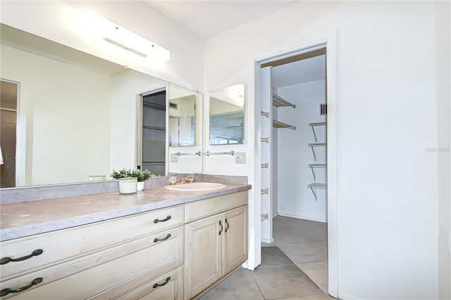 14130 Rosemary Ln Unit 4215, Largo, FL 33774 - bathroom with vanity, a spacious closet, and tile patterned floors
