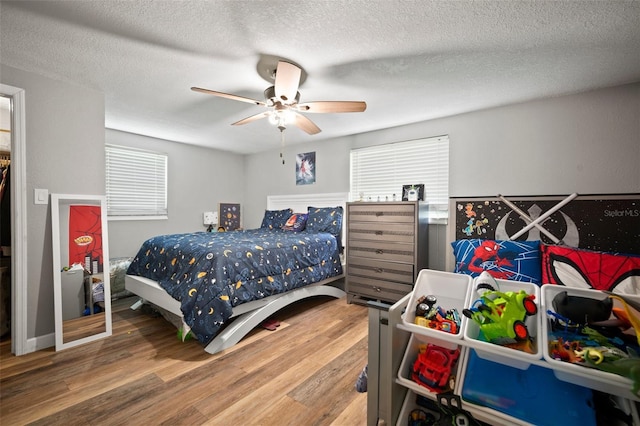 903 Dixie Maid Ln, Valrico, FL 33594 - bedroom with wood finished floors, a textured ceiling, and a ceiling fan