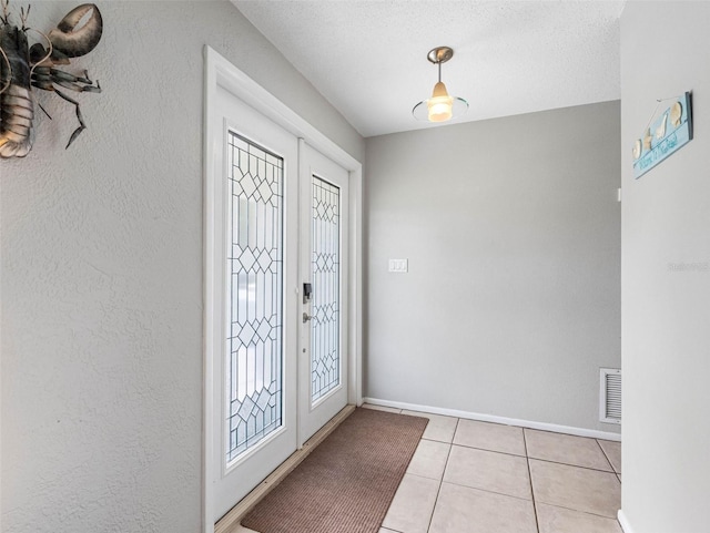 9109 134th Way, Seminole, FL 33776 - foyer featuring light tile patterned floors and a textured ceiling