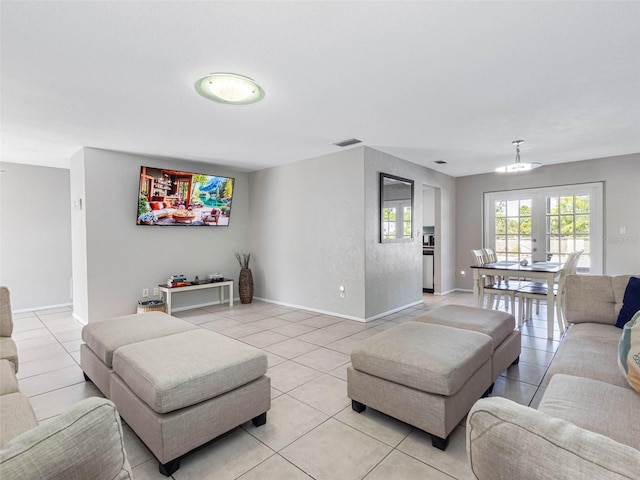 9109 134th Way, Seminole, FL 33776 - living room featuring light tile patterned flooring and baseboards
