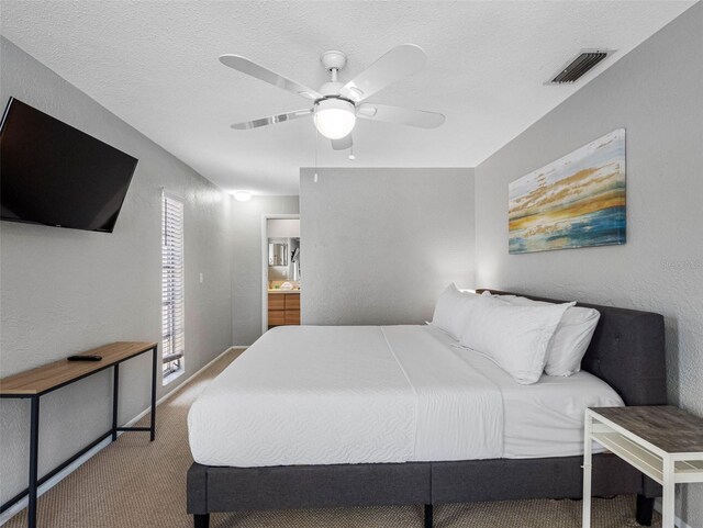 9109 134th Way, Seminole, FL 33776 - bedroom featuring carpet floors, a textured wall, ensuite bathroom, ceiling fan, and a textured ceiling