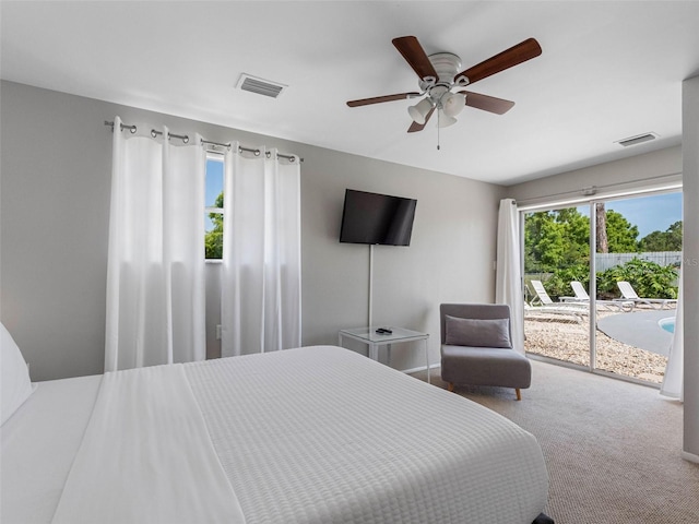 9109 134th Way, Seminole, FL 33776 - bedroom with access to exterior, carpet, and a ceiling fan