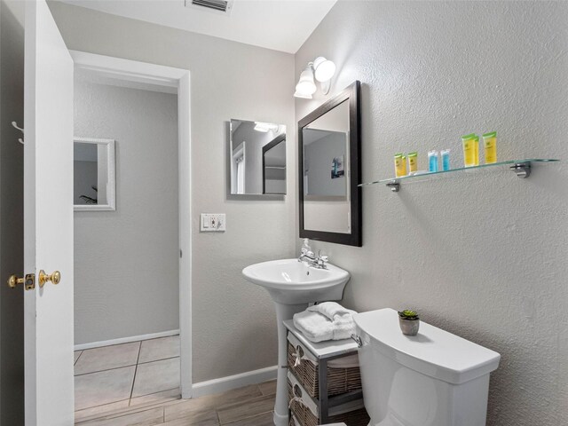 9109 134th Way, Seminole, FL 33776 - half bathroom with toilet and wood finished floors