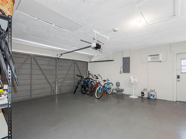 9109 134th Way, Seminole, FL 33776 - garage featuring electric panel, a garage door opener, and a wall mounted AC