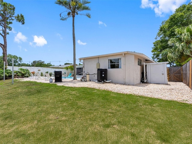 9109 134th Way, Seminole, FL 33776 - back of house with stucco siding, a fenced backyard, a gate, and a patio