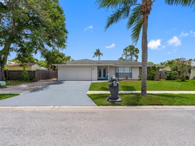 9109 134th Way, Seminole, FL 33776 - ranch-style home featuring french doors, an attached garage, driveway, and stucco siding