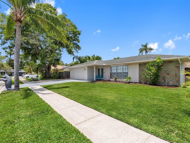 9109 134th Way, Seminole, FL 33776 - single story home featuring an attached garage, driveway, stucco siding, a front yard, and stone siding