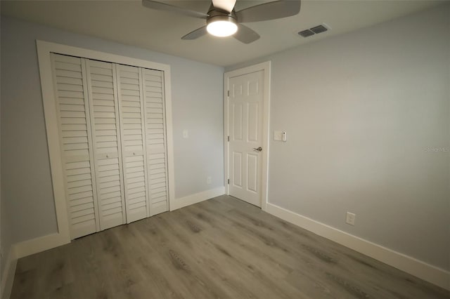 8405 N Willow Ave, Tampa, FL 33604 - unfurnished bedroom featuring wood finished floors, a closet, and ceiling fan