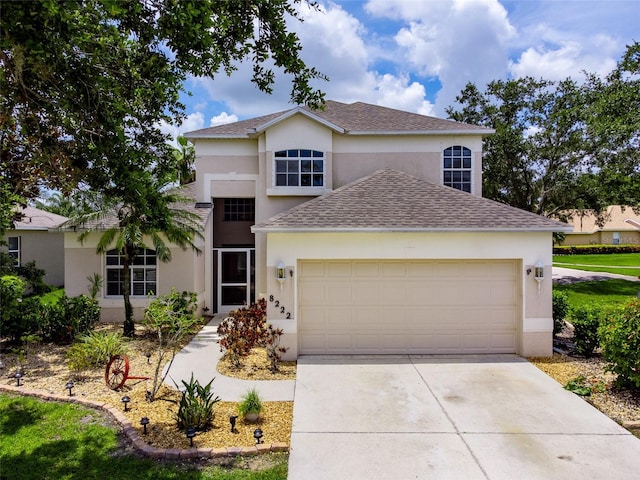 8222 Haven Harbour Way, Bradenton, FL 34212 - traditional home featuring stucco siding, roof with shingles, an attached garage, and concrete driveway