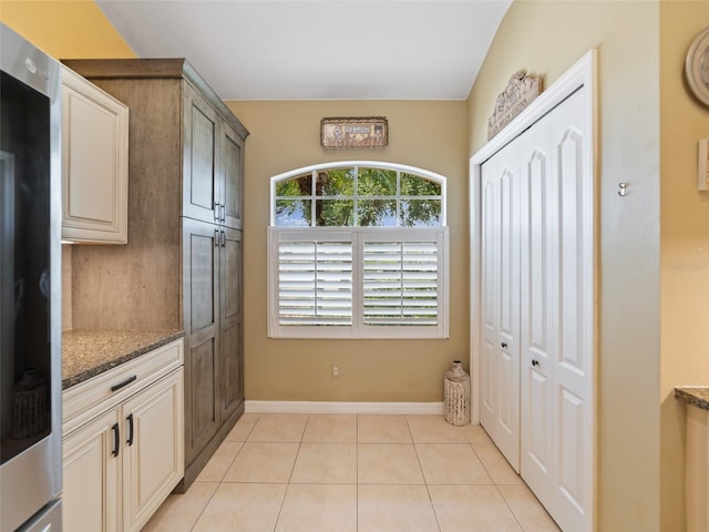 8222 Haven Harbour Way, Bradenton, FL 34212 - kitchen with dark stone countertops, light tile patterned floors, and smart refrigerator
