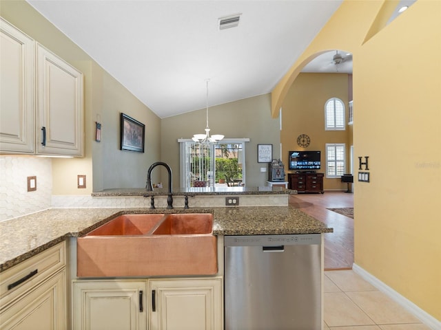 8222 Haven Harbour Way, Bradenton, FL 34212 - kitchen with dishwasher, arched walkways, stone counters, a chandelier, and high vaulted ceiling