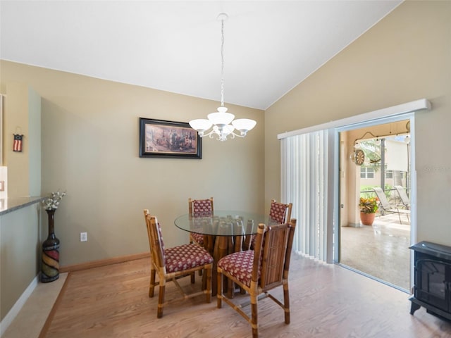 8222 Haven Harbour Way, Bradenton, FL 34212 - dining space with a chandelier, lofted ceiling, wood finished floors, and a wood stove