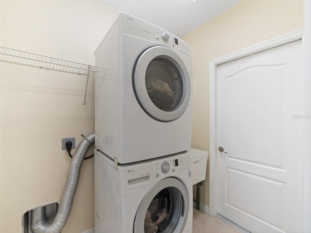 8222 Haven Harbour Way, Bradenton, FL 34212 - laundry area with stacked washing machine and dryer and light tile patterned flooring