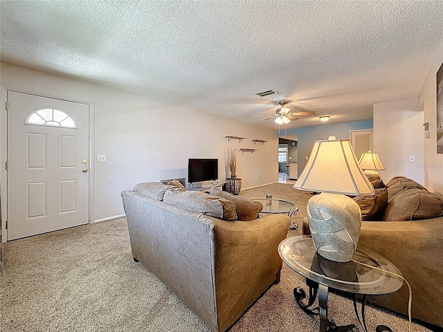 1102 Cara Dr, Largo, FL 33771 - living room with light colored carpet, a ceiling fan, a textured ceiling, and healthy amount of natural light