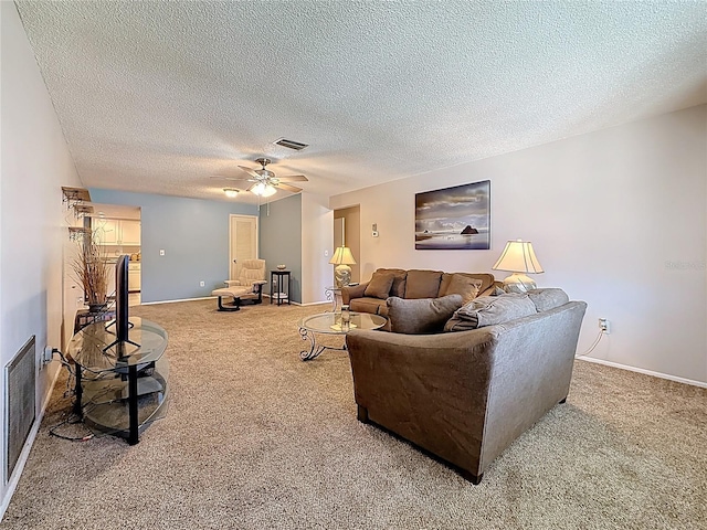 1102 Cara Dr, Largo, FL 33771 - living room featuring carpet flooring, ceiling fan, and a textured ceiling
