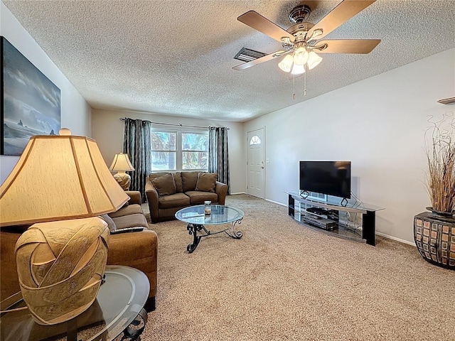 1102 Cara Dr, Largo, FL 33771 - carpeted living area featuring a textured ceiling and ceiling fan
