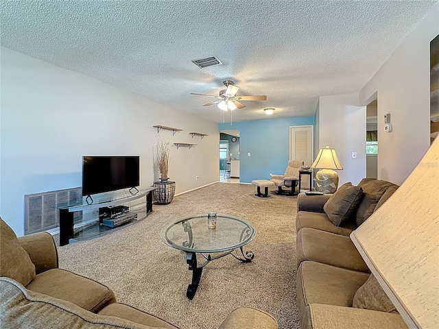 1102 Cara Dr, Largo, FL 33771 - carpeted living area featuring a ceiling fan and a textured ceiling