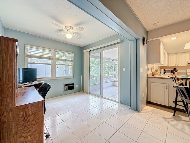 1102 Cara Dr, Largo, FL 33771 - kitchen with ceiling fan, a textured ceiling, light tile patterned flooring, a desk, and white cabinets