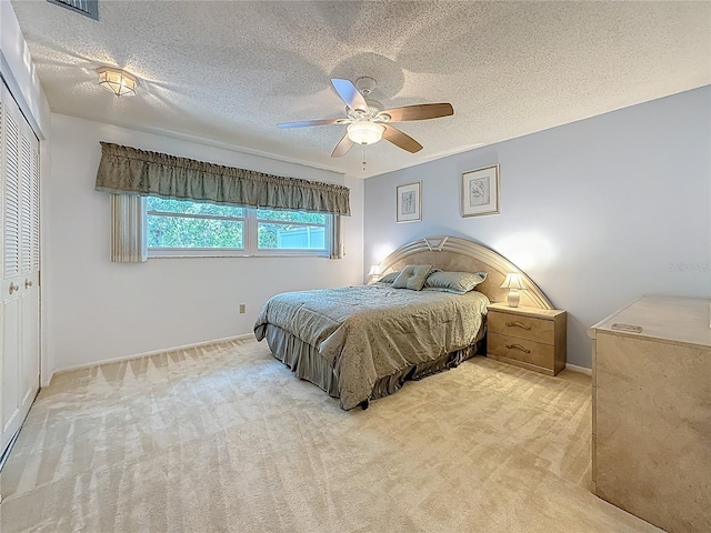 1102 Cara Dr, Largo, FL 33771 - bedroom with carpet floors, a closet, a ceiling fan, and a textured ceiling