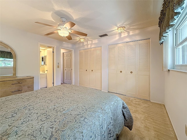 1102 Cara Dr, Largo, FL 33771 - carpeted bedroom featuring two closets and ceiling fan